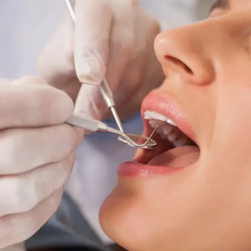 dentisda examinando aos dentes da paciente
